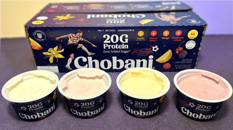 Four open containers of Chobani protein yogurt in front of box