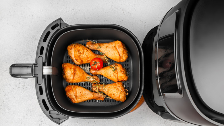 Roasted chicken drumsticks in an air fryer basket