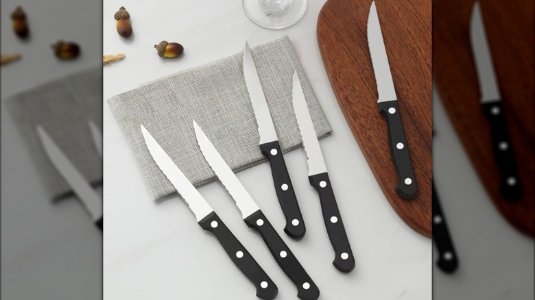 Knives on table next to a cutting board