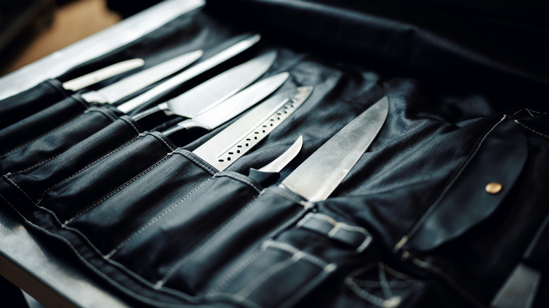 Knives sitting in a leather case