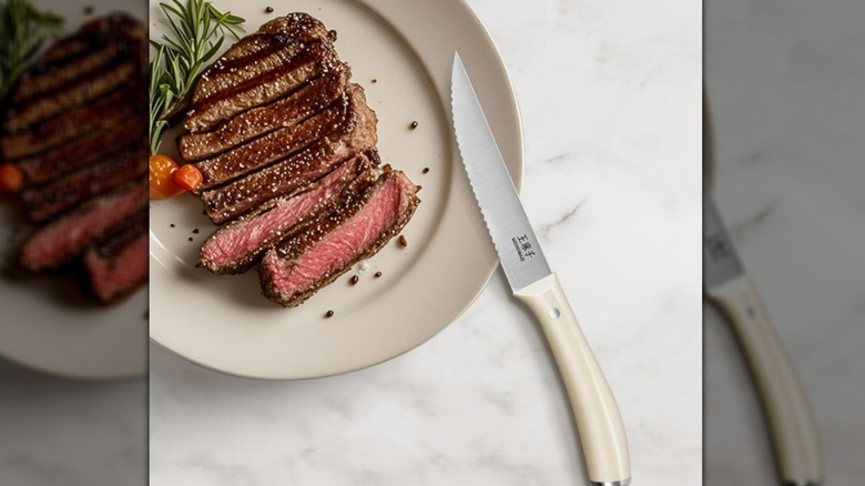 Knife and steak on plate