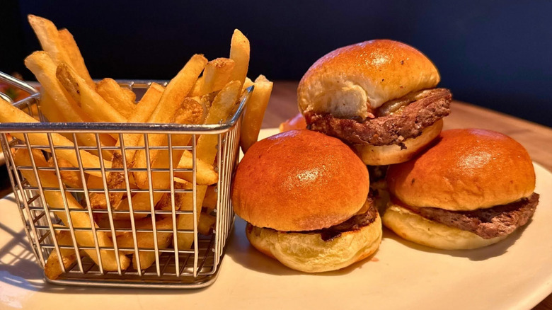 Sliders and fries from Yard House on a white plate