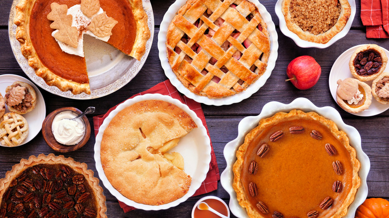 A variety of pies on a wooden table