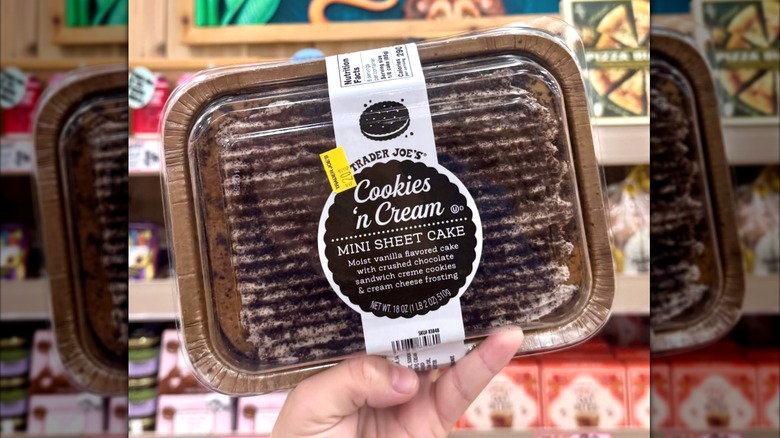 Close up of Trader Joes Cookies & Cream Mini Sheet Cake being held up by a hand at the store
