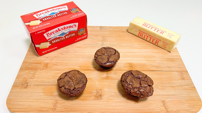 A box of Breakstone's Unsalted Butter next to a stick of butter and three brownie bites