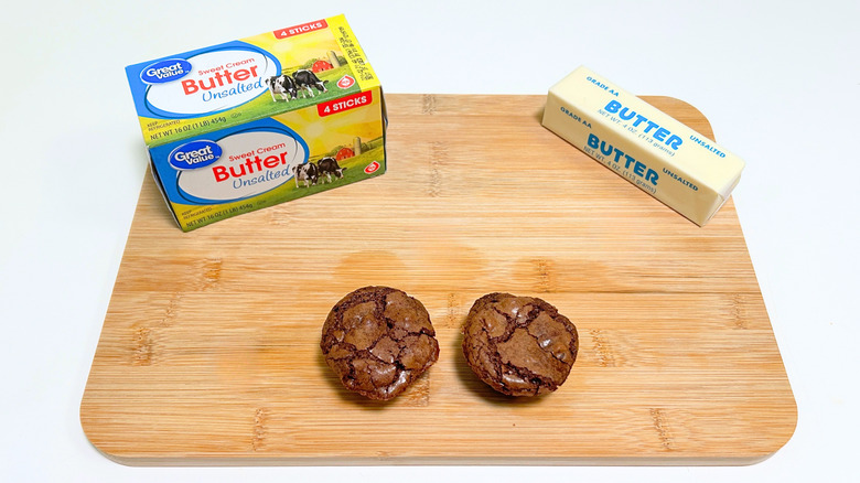 A box of Great Value Sweet Cream Unsalted Butter next to a stick of butter and brownie bites