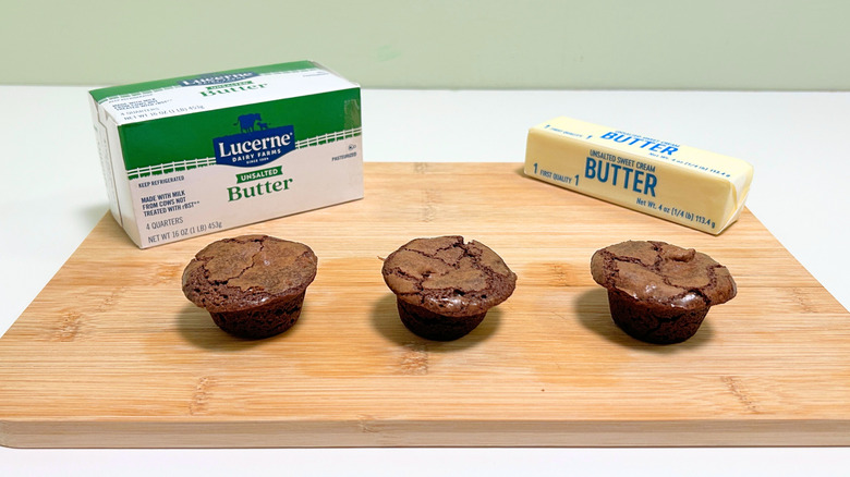 A box of Lucerne Unsalted Butter next to a stick of butter and three brownie bites