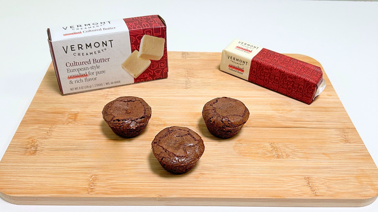 A box of Vermont Creamery Cultured European-Style Butter next to a stick of butter and three brownie bites