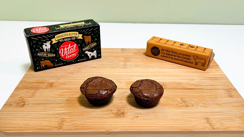 A box of Vital Farms Unsalted Butter next to a stick of butter and two brownie bites