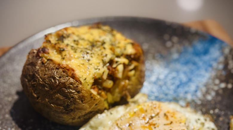 Baked potato stuffed with bolognese sauce and cheese