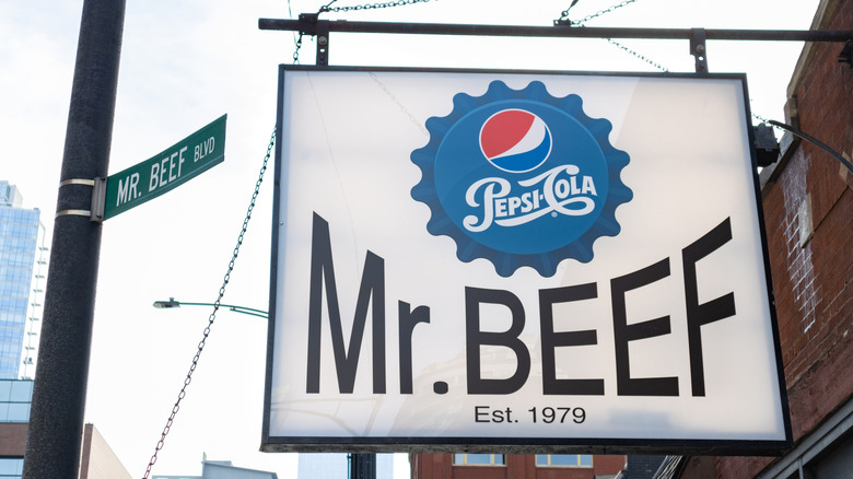 A large sign reading "Mr. Beef Est. 1979" with an image of a Pepsi-Cola bottle cap above, next to a "Mr. Beef Blvd" street sign