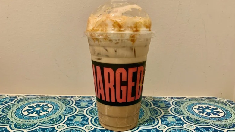 A Panera Bread iced caramel latte in a plastic cup