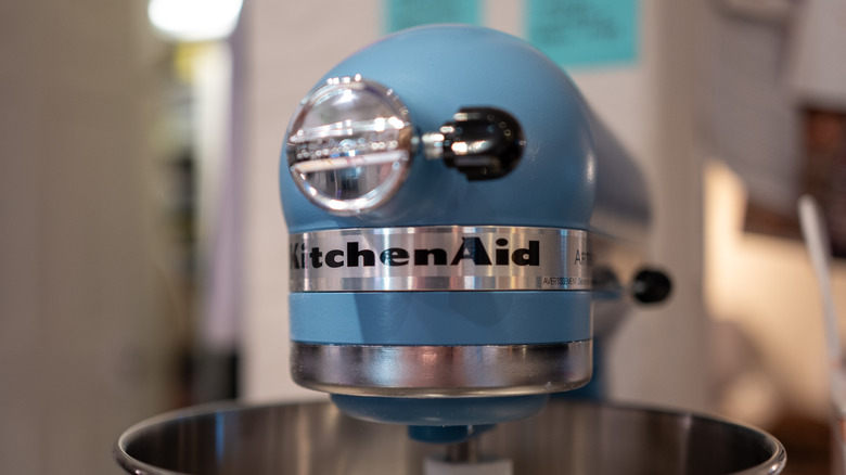 Closeup of KitchenAid logo on a light blue stand mixer