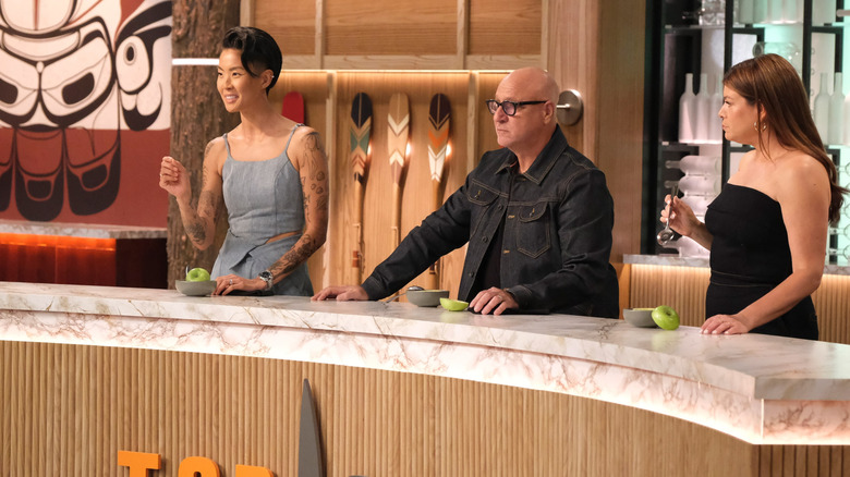 Top Chef hosts trying an apple dish