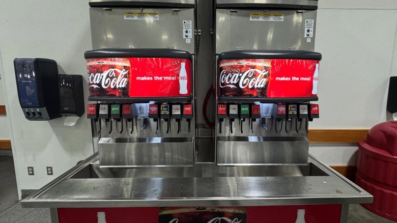 Costco food court soda dispensers with Coca-Cola products