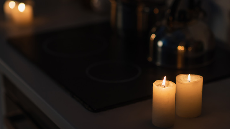 Candles surround an electric stovetop during power outage