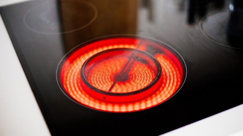Red electric cooktop burner turned on