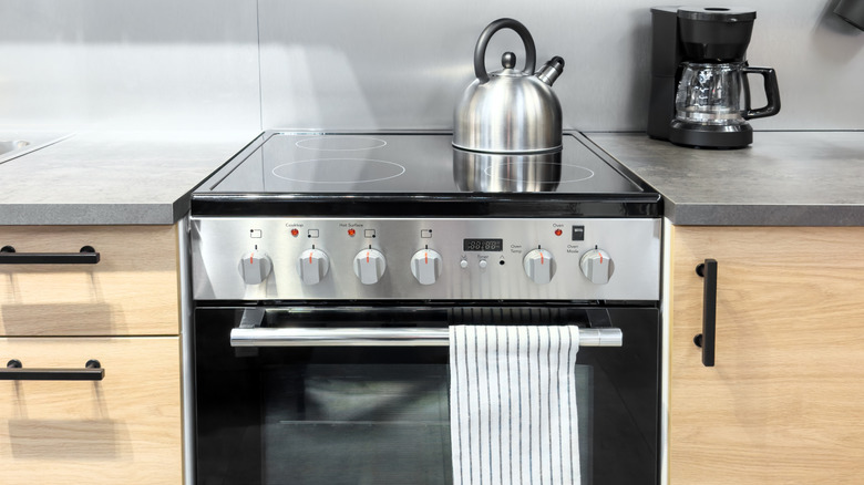 Electric stove with a tea kettle on top of it