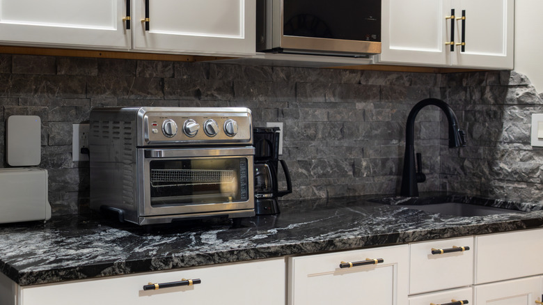 A stainless steel toaster oven taking up a lot of counter space