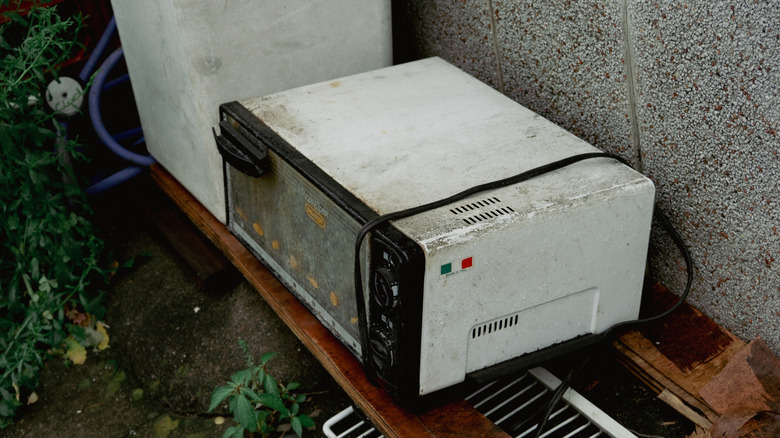 An old, dirty, abandoned toaster oven