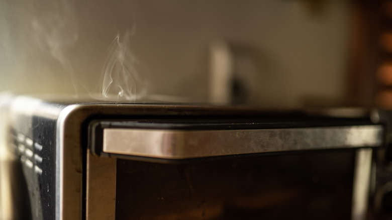 Closeup of toaster oven smoking from top
