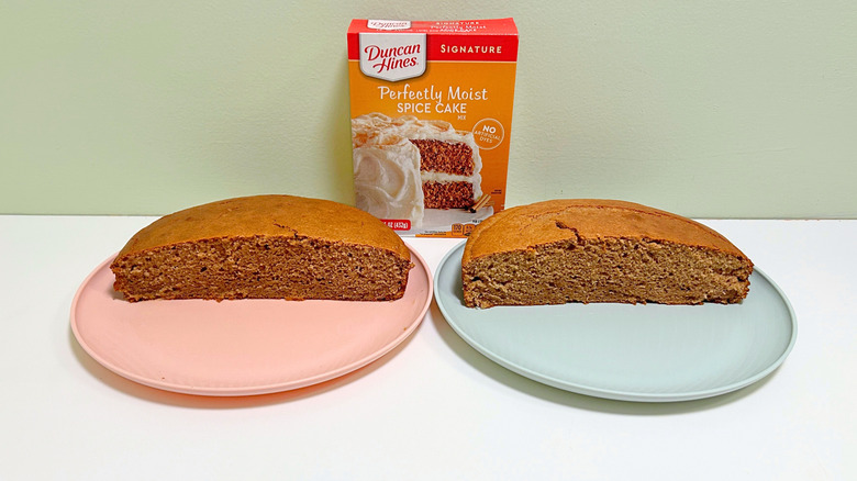 A box of Duncan Hines Perfectly Moist Spice Cake Mix next to two plates of cake