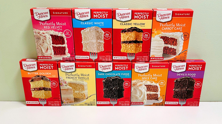 Several boxes of Duncan Hines cake mix lined up together in two rows