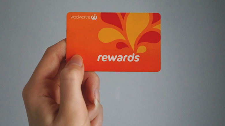 hand holding reward card in the air