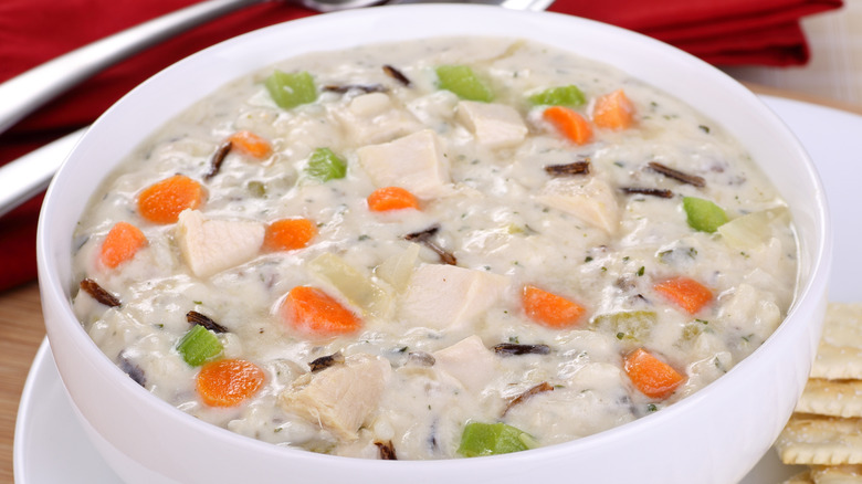 Bowl of cream of chicken soup with rice, veggies, and chunks of chicken