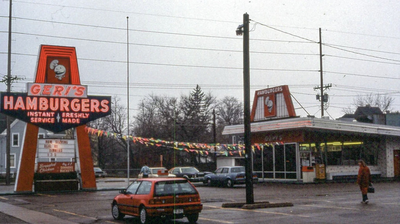 Shot of Geri's Hamburgers location showing the parking lot, sign, and restaurant exterior