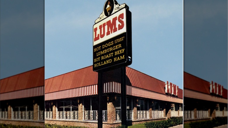 Sign for Lums featuring "Hot Dogs, Lumburger, Hot Roast Beef, Holland Ham" outside of a storefront.