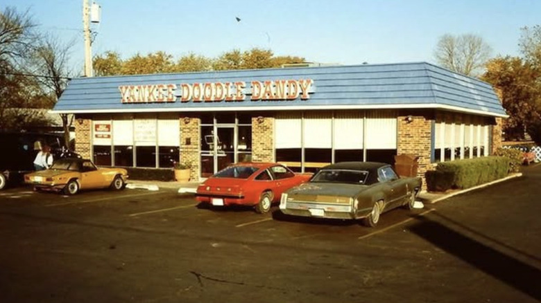 Storefront of Yankee Doodle Dandy location with three cars in the parking lot