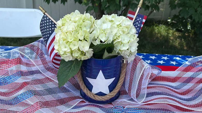 Blue bucket with a white star used as centerpiece on American flag-themed table
