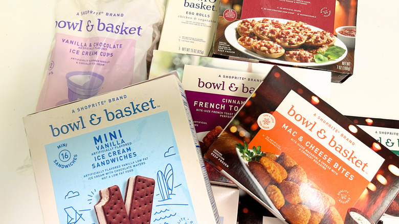 Several Bowl and Basket frozen snacks piled together on a white background