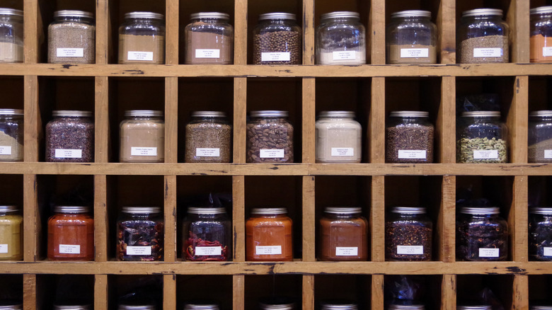 Spices on wooden shelves