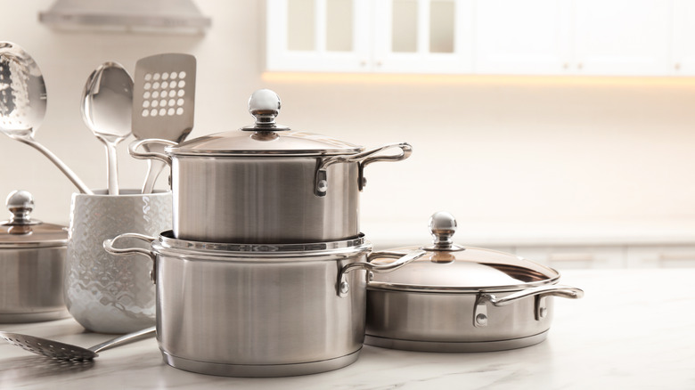 Generic cookware set sitting on counter next a jar with utensils
