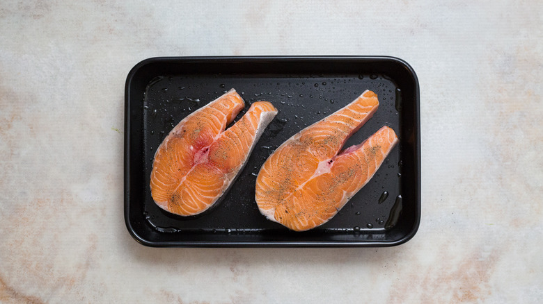 raw salmon steaks in pan