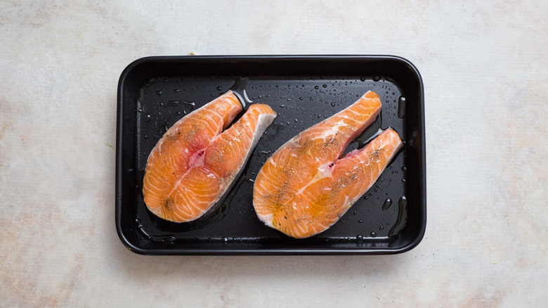 raw salmon steaks in pan