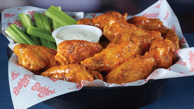 Chicken wings and celery in basket with ranch