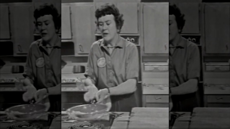 Julia Child flipping mashed potatoes out of a pan