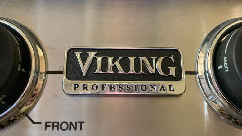 A close up of a Viking professional range with a logo plate and burner dials