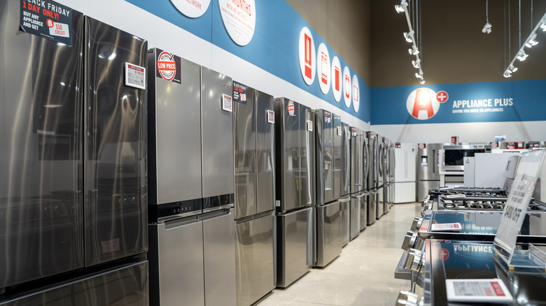 Refrigerators and ranges on display at an appliance store