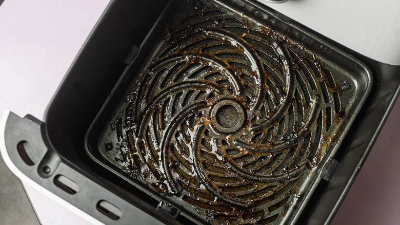 Air fryer with visible grease on the basket