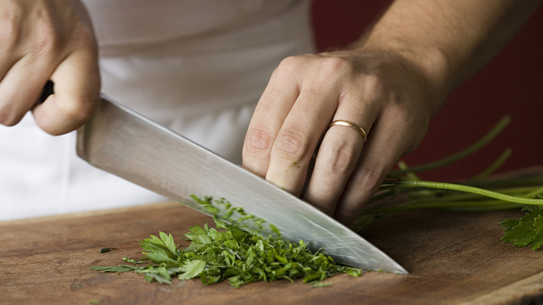 Chopping Cilantro on wooden cutting board