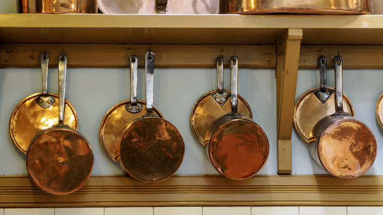 Copper pans hanging on wall