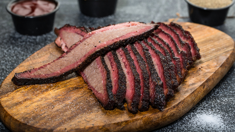 Beef brisket sliced and served on a wooden platter