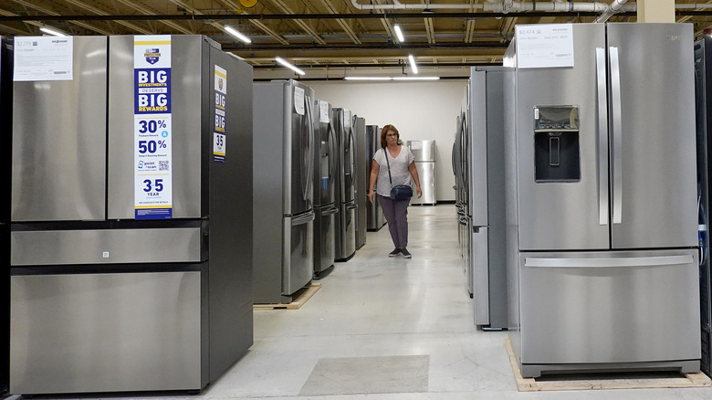 lines of refrigerators for sale in a store