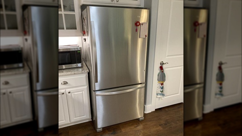 A stainless steel bottom freezer refrigerator with one large top door