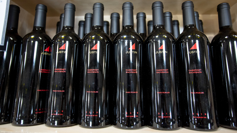 rows of bottles of justin cabernet on store shelf