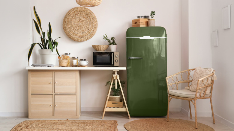 A green vintage-style refrigerator in a modern kitchen